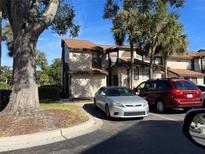 Inviting two-story townhouse showcasing neutral colors, a well-kept lawn and a paved area for convenient parking at 3036 S Semoran Blvd # S, Orlando, FL 32822