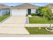 Charming single-story home featuring a well-manicured lawn and a welcoming, neutral-toned facade at 739 Jefferson, Davenport, FL 33837