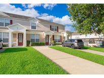 Inviting townhome with well-manicured lawn and private driveways at 8112 Princess Palm Ln, Kissimmee, FL 34747