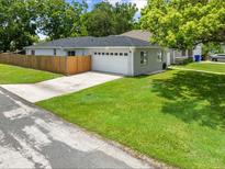 Charming single-story home with a well-maintained lawn and an attached two-car garage at 1501 Delaware Ave, St Cloud, FL 34769