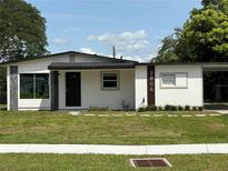 Charming single-story home featuring a well-manicured lawn and modern architectural details at 2806 Bonneville Dr, Orlando, FL 32826