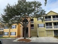 Multi-story condo building featuring a private garage and balconies on the first and second levels at 5017 City St # 1938, Orlando, FL 32839