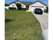 Charming single-Gathering home featuring a well-maintained lawn and attached garage at 506 Myakka Pl, Kissimmee, FL 34759