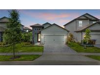 Charming single-Gathering home featuring a two-car garage, stone accents, and a well-manicured lawn in a suburban neighborhood at 7848 Somersworth Dr, Kissimmee, FL 34747