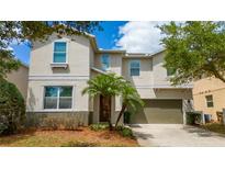 Charming two-story home with a well-manicured lawn and a two-car garage at 1006 Tourmaline Dr, Kissimmee, FL 34746