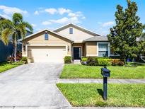 Charming single-story home with a well-manicured lawn, mature trees, and a two-car garage at 1940 Banner Ln, St Cloud, FL 34769