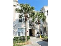 Condo exterior featuring two palm trees out front at 3351 Whitestone Cir # 204, Kissimmee, FL 34741