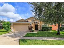 Single-Gathering home with a two-car garage and lawn at 2005 Royal Ridge Dr, Davenport, FL 33896