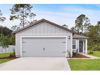 Charming single-Gathering home featuring a two-car garage, well-manicured lawn, and a welcoming entryway at 14927 Sw 25Th Cir, Ocala, FL 34473