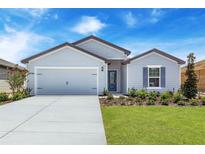 Charming single-story home featuring a well-manicured lawn, a two-car garage, and a welcoming front entrance at 418 Marion Oaks Ln, Ocala, FL 34473