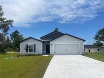 Charming single-Gathering home with a two-car garage and well-manicured lawn at 420 Marion Oaks Ln, Ocala, FL 34473