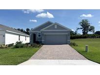 Charming single-story home featuring a brick driveway and a well-manicured lawn at 4063 Nw 44Th Cir, Ocala, FL 34482