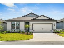 Charming single-story home with a well-manicured lawn, two-car garage and neutral color scheme at 6837 Sw 90Th Loop, Ocala, FL 34476
