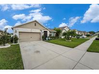 Charming single-Gathering home with a well-manicured lawn, complemented by a spacious driveway and beautiful landscaping at 2272 Rose Blvd, Winter Haven, FL 33881