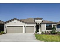 Charming single-story home featuring a well-manicured lawn, neutral stucco siding, and a two-car garage at 4457 Sw 84Th Street Rd, Ocala, FL 34476