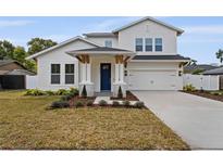 Two-story house with white siding, blue door, and landscaped yard at 2724 Oxford St, Orlando, FL 32803