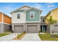 Charming two-story townhome featuring attached garages and colorful accents at 4337 Hillock Blvd, Haines City, FL 33844