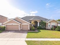 Beautiful two-story home with a large front yard and two-car garage at 4204 Sevan Way, Kissimmee, FL 34746