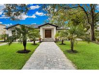 A charming house with a nicely landscaped lawn and walkway at 1716 Palmer Ave, Winter Park, FL 32789