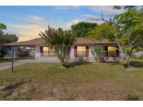 Single-story home with a brick facade and a landscaped lawn at 9324 Se Maricamp Rd Se Rd, Ocala, FL 34472