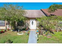 Front view of a charming condo with a well-maintained lawn and walkway at 3017 Jon Jon Ct, Orlando, FL 32822
