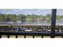 Scenic waterfront view with boats and lush trees at 1640 Juno Trl # 202E, Astor, FL 32102