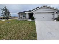 One-story house with a two-car garage and a well-maintained lawn at 1524 Fleur Dr, Davenport, FL 33837