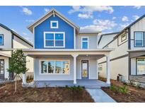 Charming two-story home featuring a welcoming front porch, blue accents and well-maintained landscaping at 3007 Mirage Pl, St Cloud, FL 34771