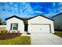 One story home with attached garage and landscaping at 13454 Leaping Water Way, Astatula, FL 34705