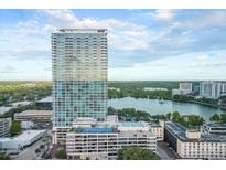 Stunning aerial view of condo building by a lake with surrounding green space and city at 150 E Robinson St # 221, Orlando, FL 32801