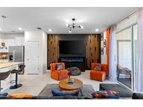 Stylish living room showcasing a modern fireplace, sleek furniture, and contemporary lighting fixtures at 7614 Oak Spring Ln, Davenport, FL 33837