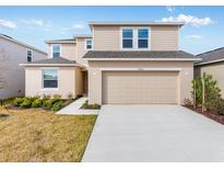 Charming two-story home featuring a spacious two-car garage and well-maintained landscaping at 4430 Petunia St, Lake Hamilton, FL 33851
