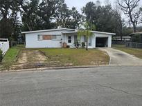 Ranch style home with a single car garage and a spacious front yard at 132 Baywood Dr, Daytona Beach, FL 32117