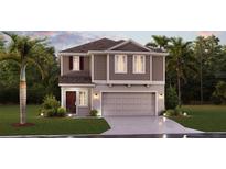 Two-story house with brown siding, attached garage, and landscaping at 673 Bell Prairie Cir, Lake Wales, FL 33859