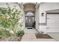 Inviting front door with sidelights, transom window, and decorative wreath, leading to a well-maintained home at 6453 Polly Lane, Lakeland, FL 33813