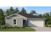 One-story house with gray siding, white garage door, and landscaped lawn at 1954 Sarah Ln, Winter Haven, FL 33884