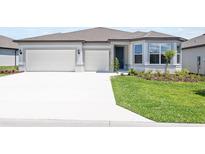 Beautiful single-story home featuring a three car garage, freshly cut lawn, and meticulously maintained landscaping at 4471 Sw 84Th Street Rd, Ocala, FL 34476