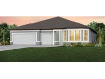 Two-story home with gray exterior, three-car garage, and landscaping at 4471 Sw 84Th Street Rd, Ocala, FL 34476