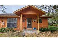 Inviting exterior of a ranch-style home with stone pathway at 469 Blue Heron Cir # 469, River Ranch, FL 33867