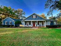 Beautiful blue house with a large front yard and porch at 2300 Se 73Rd Loop, Ocala, FL 34480