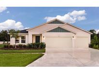 Two-story house with three-car garage and landscaped lawn at 1609 Hummingbird Rd, Winter Haven, FL 33884