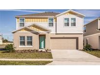 Two-story house featuring a two-car garage and landscaped front yard at 1596 Ellesmere Ave, Haines City, FL 33844