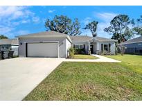 Newly constructed home with a two-car garage and well-manicured lawn at 4714 Dail Rd, Lakeland, FL 33813