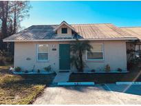 Cute single story home with green door and well-manicured landscaping at 401 Century Blvd # C, Auburndale, FL 33823