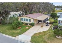 Aerial view of a single-Gathering home with golf course nearby at 1724 Magnolia Ave, Lady Lake, FL 32159