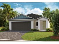 One story home with two car garage, landscaping, and driveway at 6230 Sw 96Th Pl, Ocala, FL 34476