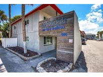 Modern building exterior with parking and signage at 900 S Peninsula Dr # 102, Daytona Beach, FL 32118
