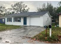 Newly painted single-story home with a one-car garage and driveway at 1227 Waterview W Blvd, Lakeland, FL 33801