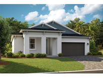 One-story home with gray siding, dark garage door, and landscaped lawn at 6225 Sw 97Th St, Ocala, FL 34476