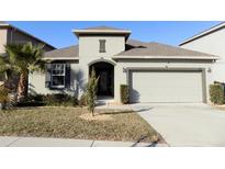 Single-story house with attached garage and landscaped front yard at 2180 Nighthawk Dr, Haines City, FL 33844